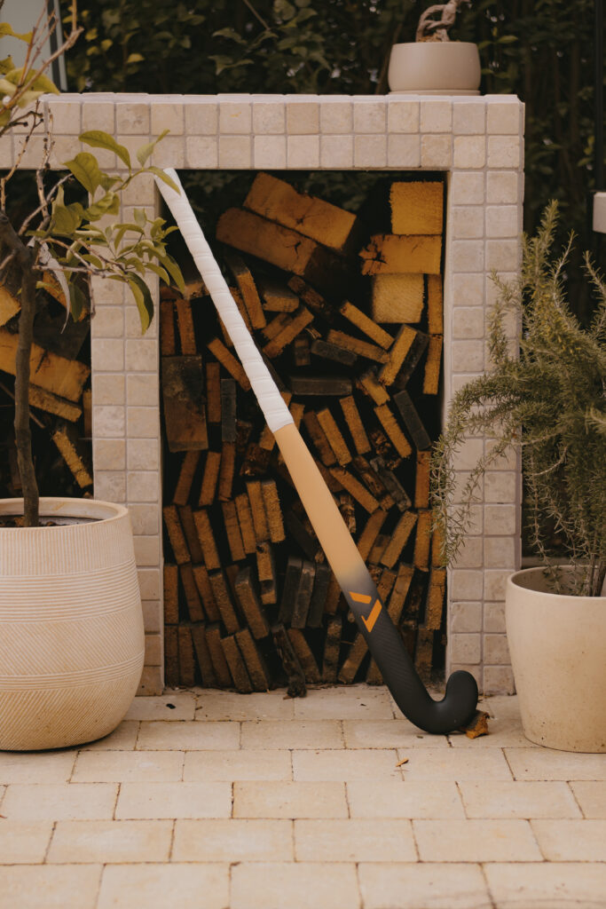 Artistic photo of A-LIFE Ibiza Drop hockey stick, inspired by Ibiza architecture and textures.