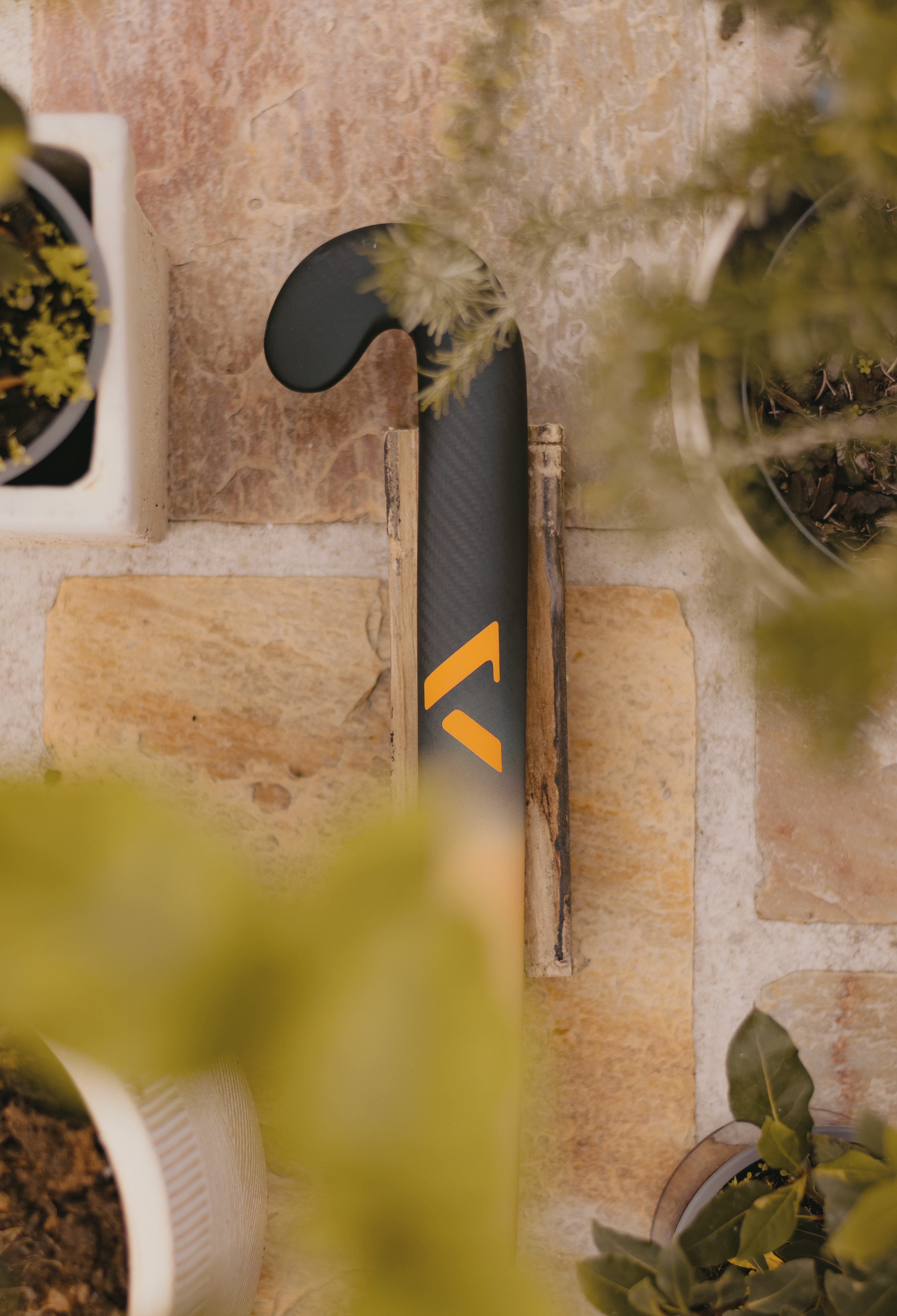 Artistic photo of A-LIFE Ibiza Drop hockey stick, inspired by Ibiza architecture and textures.