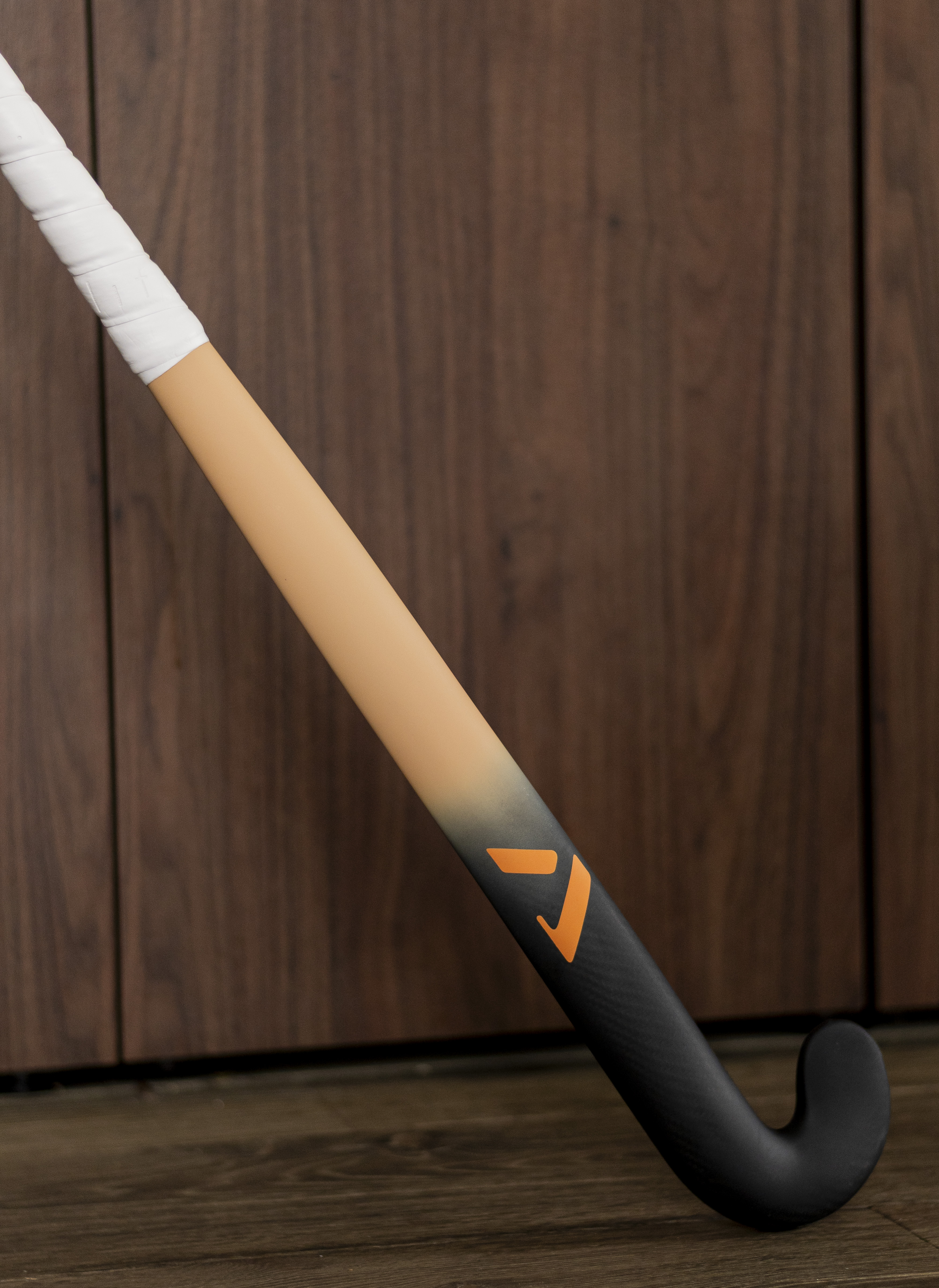 minimalist still life hockey stick dark background soft shadow artistic product photo