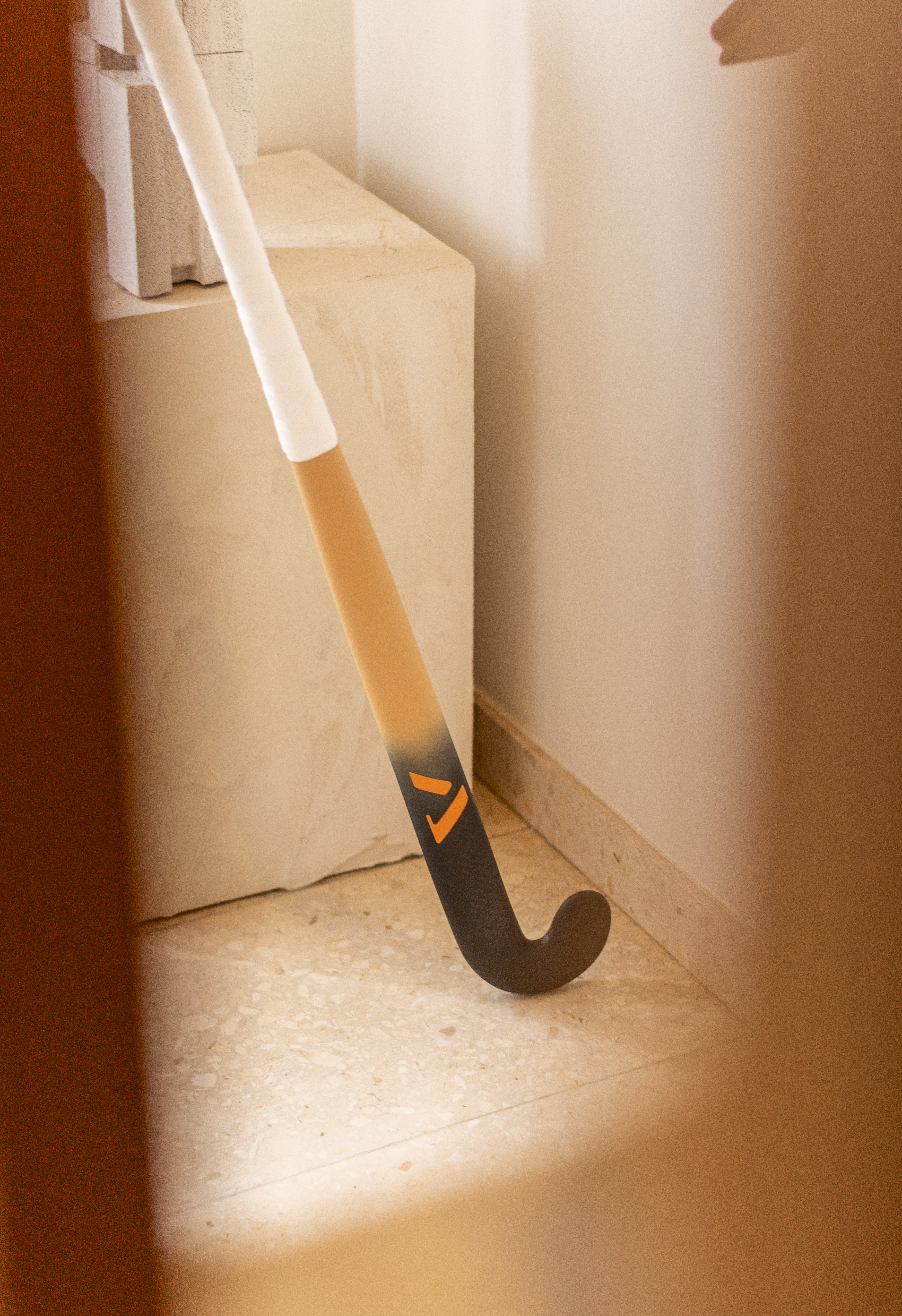 Artistic photo of A-LIFE Ibiza Drop hockey stick, inspired by Ibiza architecture and textures.