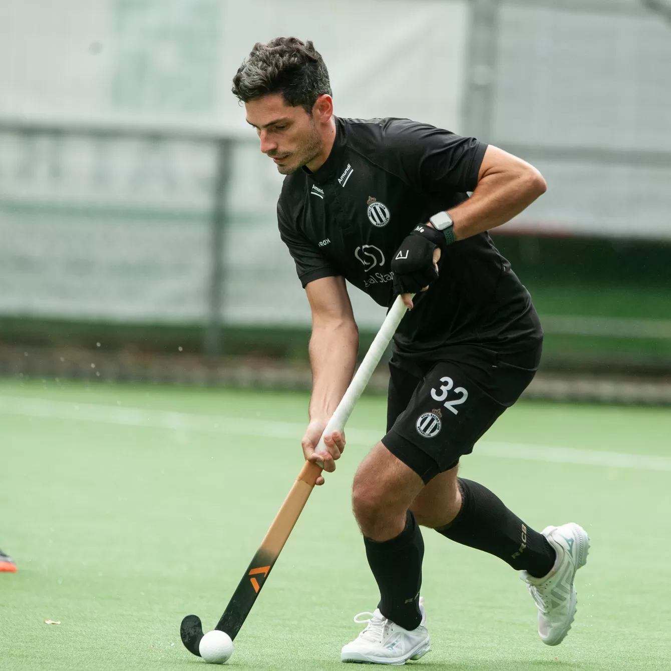 athlete holding hockey stick minimalist style beige and white tones clean composition motion blur